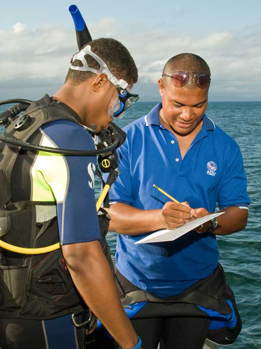 PADI Instructor Candidate receiving feedback from PADI Course Director