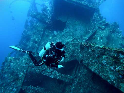 Diver swimming around a wreck